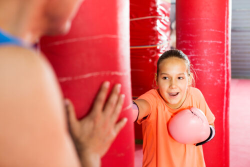 Little girl hitting punching bag