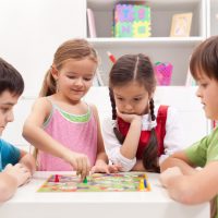 children playing board games together