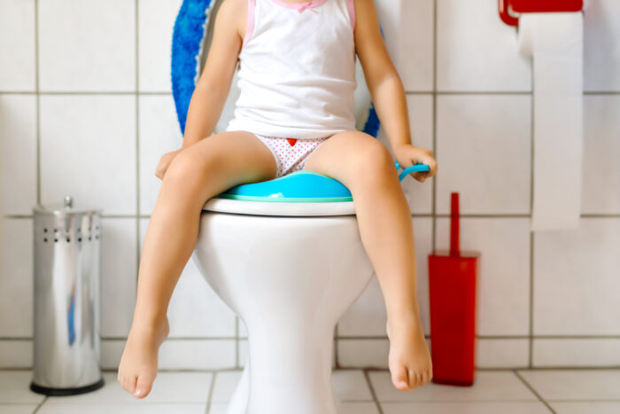 child sitting on potty seat