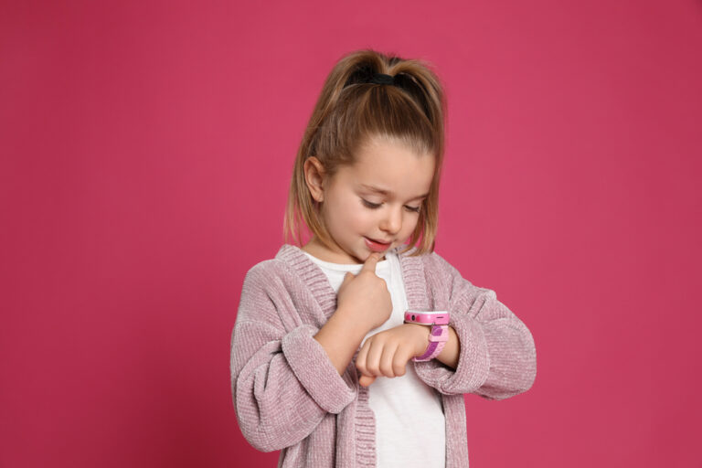 Little Girl Wearing Watch with Pink Background