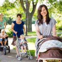 3 moms pushing strollers