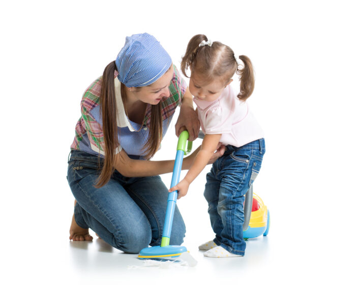 Little girl with mom using vacuum