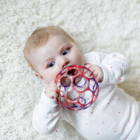 baby playing with newborn toy