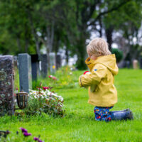 Sad child at cemetary