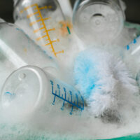 bottles washing in a bowl of soap