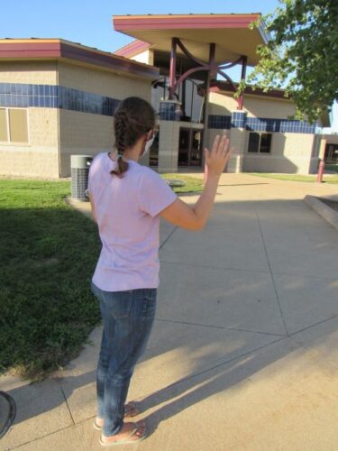 mom saying goodbye after taking kids back to school