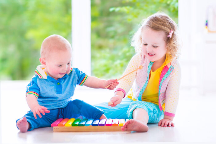 Little Children Making Music with a Xylophone