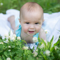 Baby girl in field with little hair