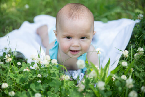 Baby girl in field with little hair