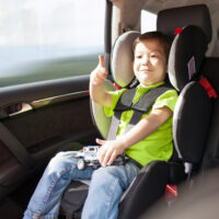 child sitting in a car seat in a vehicle