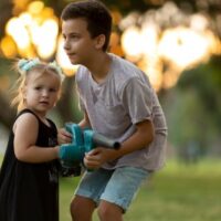 boy and girl with toy leaf blower