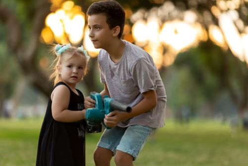 boy and girl with toy leaf blower