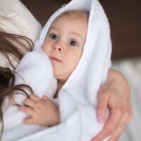 baby in white bath towel