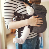 baby back facing in a baby carrier