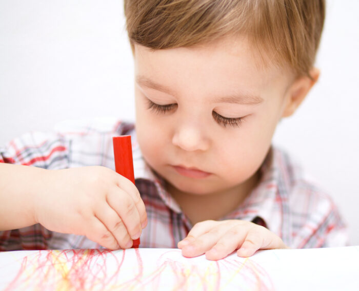 child drawing with crayon