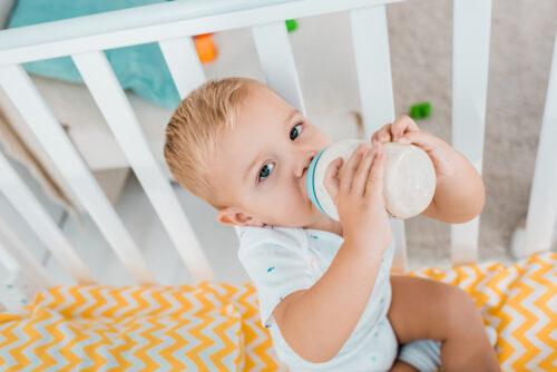 toddler drinking formula from a bottle