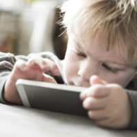 toddler playing a game on a cellphone