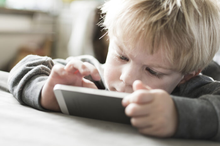 toddler playing a game on a cellphone