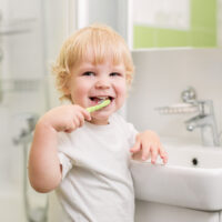 toddler brushing their teeth