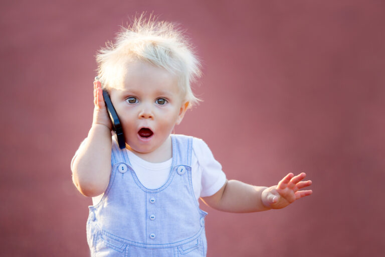 baby boy playing with cell phone toy