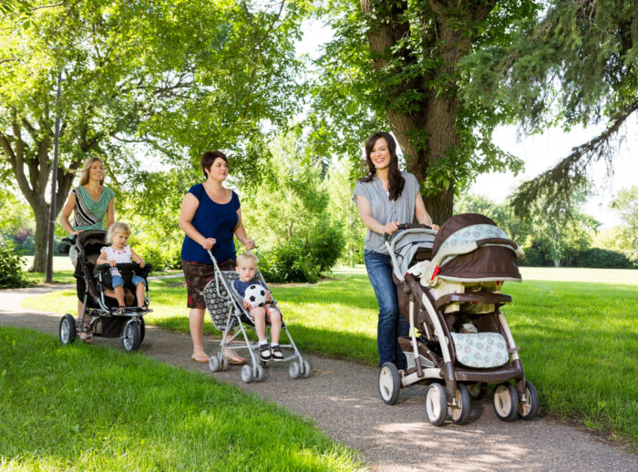 three mothers walking their babies in graco strollers in the park