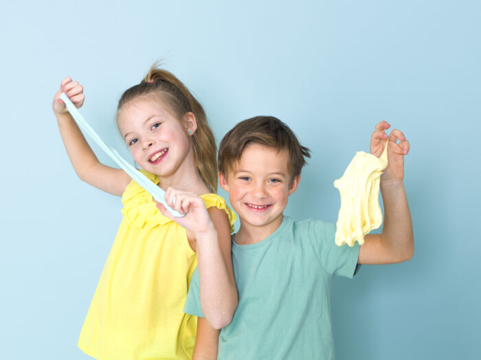 girl and boy playing with slime