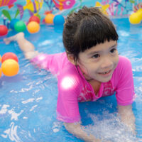kid swimming in a kiddie pool