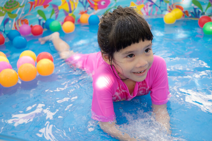 kid swimming in a kiddie pool