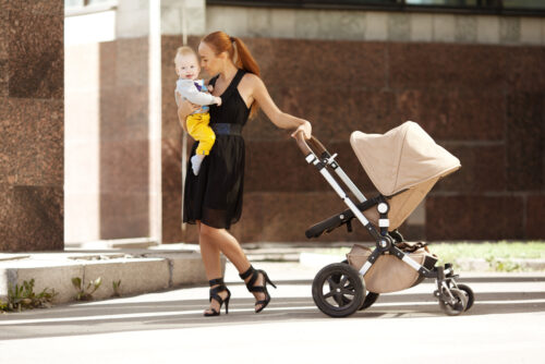 trendy mom pushing a nice stroller on city street