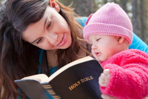 mom and baby girl reading the bible and learning about jesus