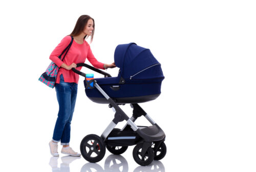 mom pushing her baby in stroller on white background