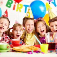 Group of kids celebrating a birthday at a party