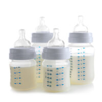 four different baby bottles isolated on a white background