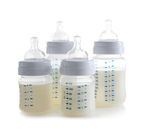 four different baby bottles isolated on a white background