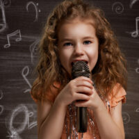 Little Girl Singing in Microphone