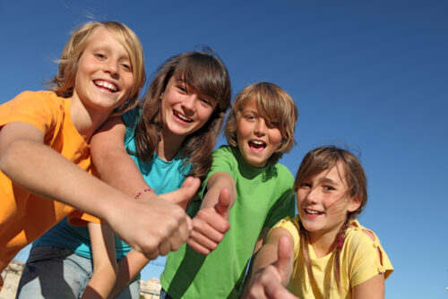 Group of Kids Outside Giving the Thumbs Up