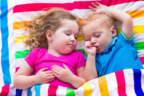 Two Sleeping Toddlers Sleeping in Toddler Bed