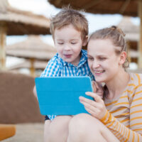 mom and son playing on tablet