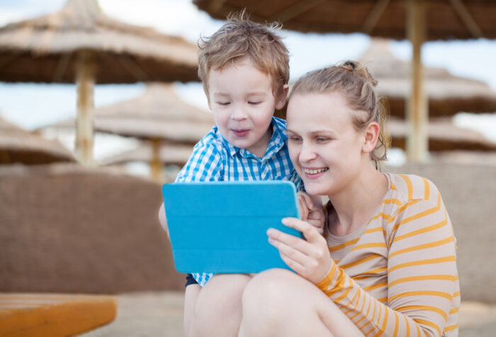 mom and son playing on tablet