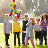 kids playing with pinata outside