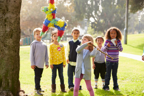 kids playing with pinata outside