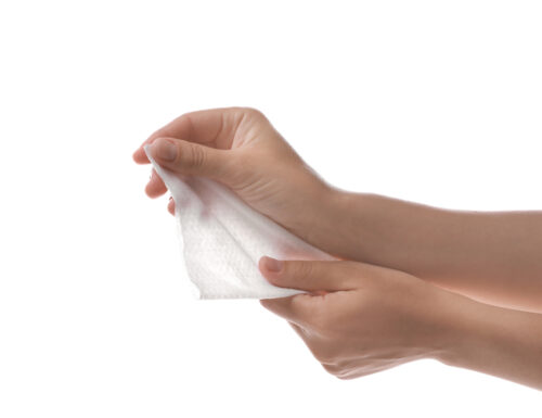 closeup of a woman's hand holding a baby wipe