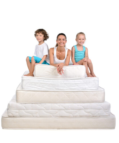 Mother and little kids sitting on a lot of mattresses, isolated on white background
