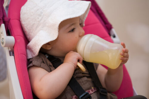 baby drinking juice from a bottle
