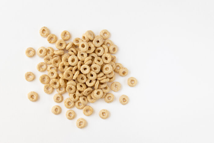 heap of cereal cheerios on white background