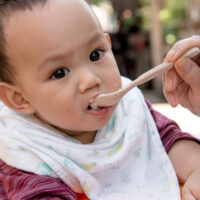 baby eating food from a spoon