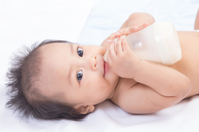 Baby Drinking Milk by Holding Her Own Bottle