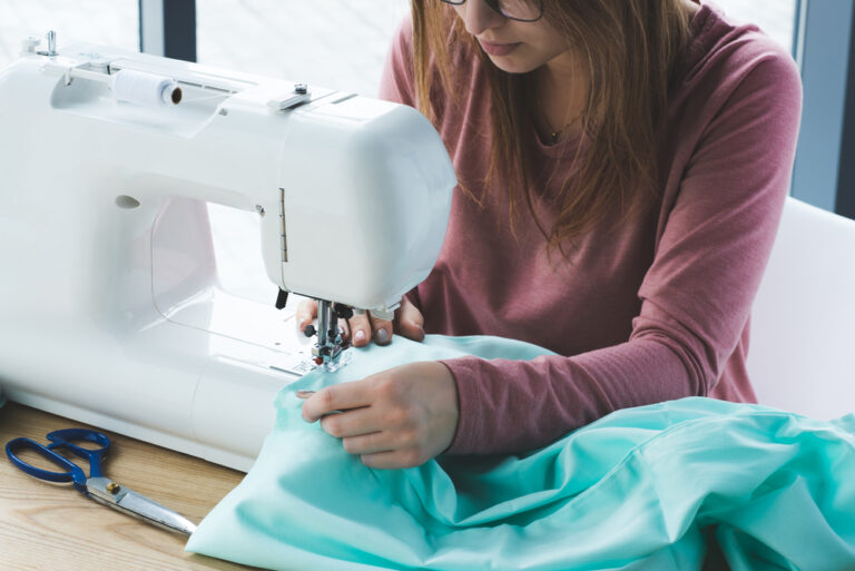 woman sewing fabric with a sewing machine