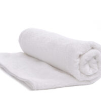 a single white towel rolled up, isolated on white background