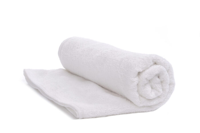 a single white towel rolled up, isolated on white background